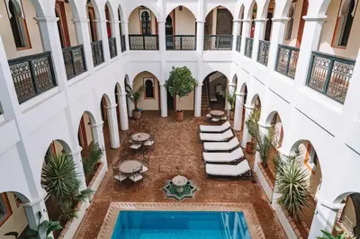 an overhead view of a courtyard with a swimming pool at Equity Point Marrakech in Marrakech