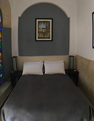 a bedroom with a large bed with two pillows at Riad Bel Haj in Marrakech