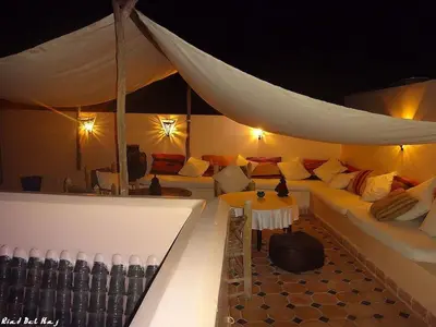a room with a tent with a couch and a table at Riad Bel Haj in Marrakech
