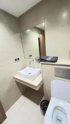 a bathroom with a sink and a toilet and a mirror at Appart Kech Menera in Marrakech
