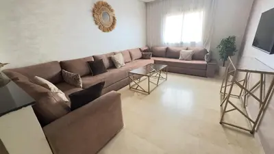 a living room with a couch and a table at Appart Kech Menera in Marrakech