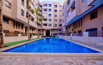 a swimming pool in the middle of a building at Appart Kech Menera in Marrakech
