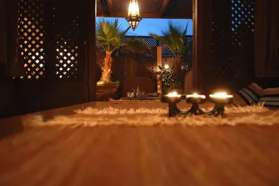 a room with a table with candles on it at Riad Aubrac in Marrakech