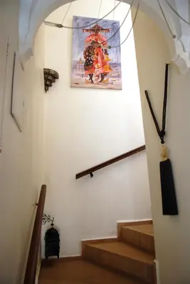 a staircase in a building with a picture on the wall at Riad Aubrac in Marrakech