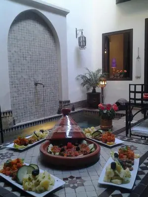a buffet with several plates of food on a table at Riad Aubrac in Marrakech