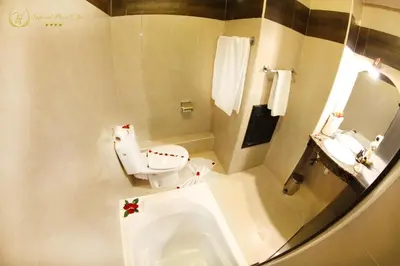 a bathroom with a toilet and a sink at Hotel Imperial Plaza & Spa in Marrakech