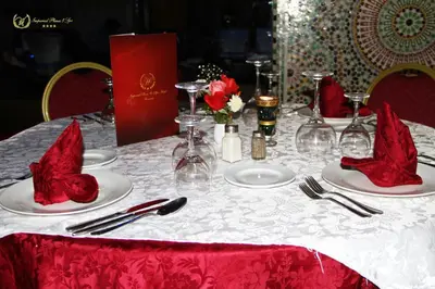 a table with red napkins on top of a white table cloth at Hotel Imperial Plaza & Spa in Marrakech