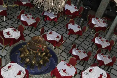 a dining room with a table and red chairs at Hotel Imperial Plaza & Spa in Marrakech