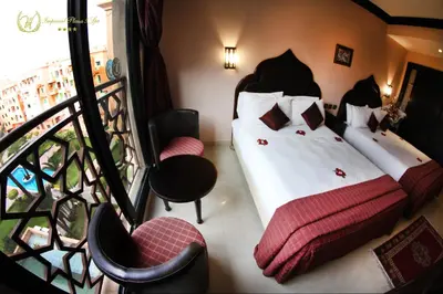 a hotel room with two beds and a balcony at Hotel Imperial Plaza & Spa in Marrakech