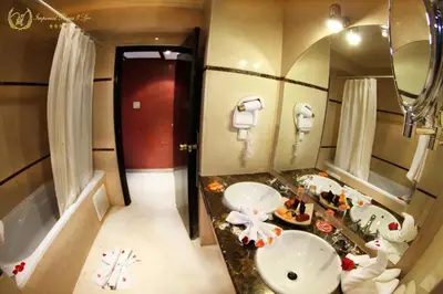 a bathroom with two sinks and a large mirror at Hotel Imperial Plaza & Spa in Marrakech