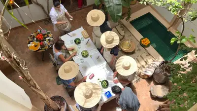 a group of people sitting at a table wearing hats at Riad Dar Zaman in Marrakech