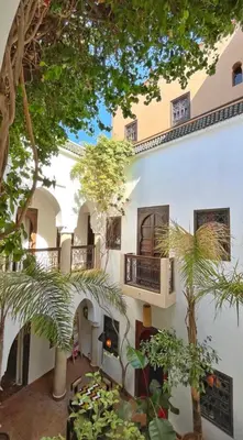 a building with balconies and trees in front of it at Riad Dar Zaman in Marrakech