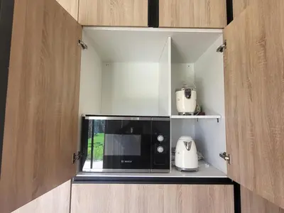 a black microwave sitting inside of a kitchen at Dar Sofia Villa in Marrakech