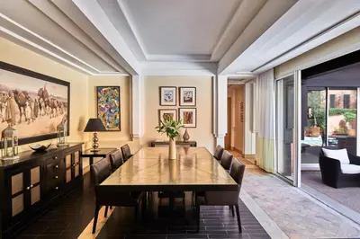 a dining room with a table and chairs at Hôtel & Ryads Barrière Le Naoura in Marrakech
