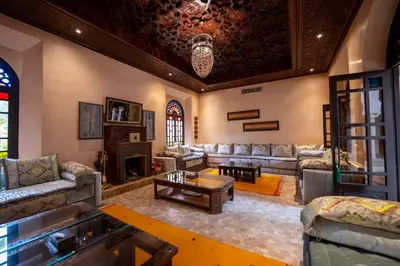 a large living room with couches and a fireplace at Al Fassia Aguedal in Marrakech