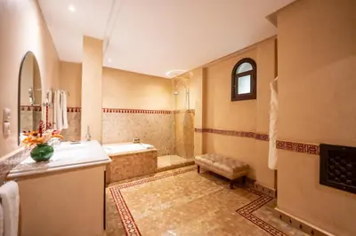 a large bathroom with a tub and a sink at Al Fassia Aguedal in Marrakech