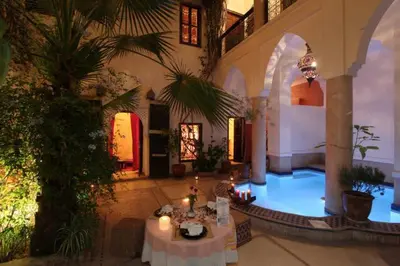 a large room with tables and candles in a building at Riad Al Faras in Marrakech