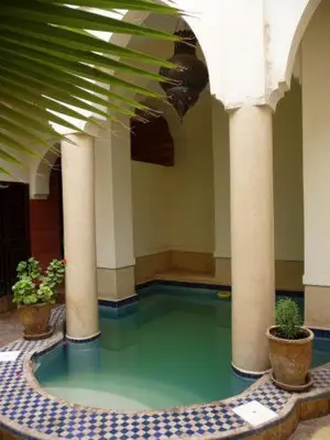 a room with a pool of water in a building at Riad Al Faras in Marrakech