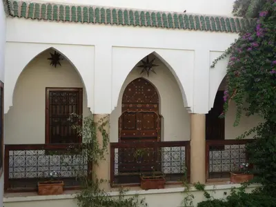 a house with two doors and a fence at Riad Al Faras in Marrakech
