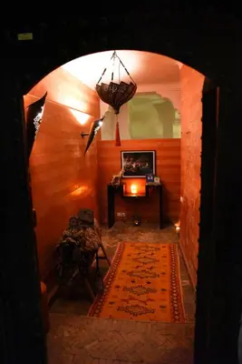an archway in a room with a table and a rug at Riad Al Faras in Marrakech