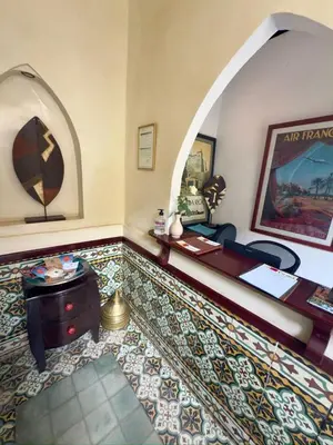 a room with a desk and a room with an arch at Riad Al Karama in Marrakech