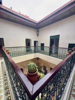 a balcony of a building with a potted plant at Riad Al Karama in Marrakech