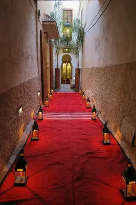 a red carpet in a hallway with candles on it at Riad Dar Justo Hotel Boutique & Spa in Marrakech