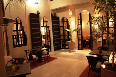 a room with tables and chairs in a restaurant at Riad Diana in Marrakech
