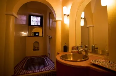 a bathroom with a gold sink in a room at Riad Dar Zaya in Marrakech