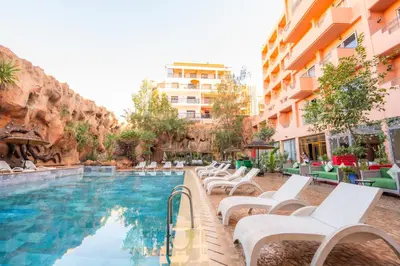 a pool at a hotel with white lounge chairs at Imperial Holiday Hôtel & spa in Marrakech