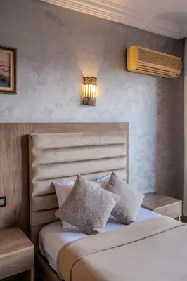 a bedroom with a bed with two white pillows at Imperial Holiday Hôtel & spa in Marrakech