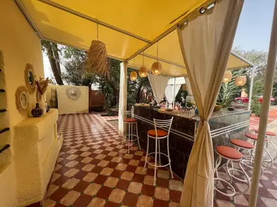 a bar with a checkered floor and bar stools at Villa Oasis de la Palmeraie in Marrakech