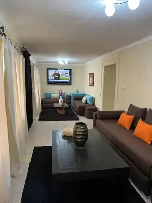 a living room with a couch and a table at Villa Oasis de la Palmeraie in Marrakech