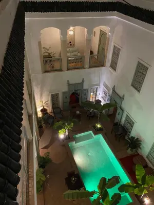 an overhead view of a house with a swimming pool at Riad Les Hibiscus in Marrakech