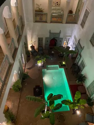 an overhead view of a pool in a house with plants at Riad Les Hibiscus in Marrakech