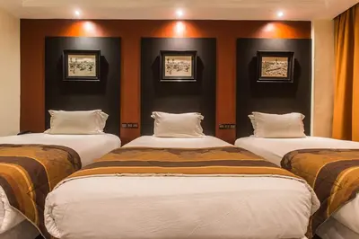 three beds in a room with black walls at El Andalous Lounge & Spa Hotel in Marrakech