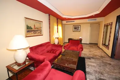 a living room with red furniture in a hotel room at El Andalous Lounge & Spa Hotel in Marrakech