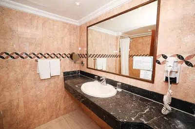 a bathroom with a sink and a mirror at El Andalous Lounge & Spa Hotel in Marrakech