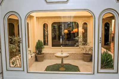 a room with a window with a table in it at The Red House in Marrakech