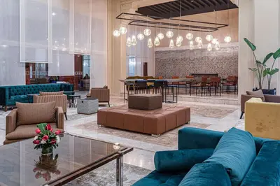 a lobby with blue couches and a table and chairs at Eden Andalou Aquapark & Spa in Marrakech