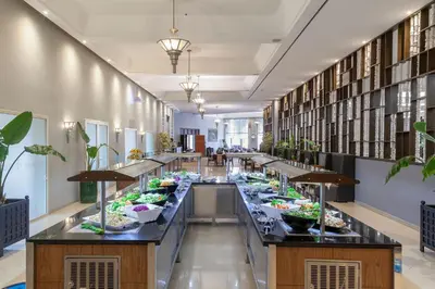 a long buffet line in a library with plants at Eden Andalou Aquapark & Spa in Marrakech