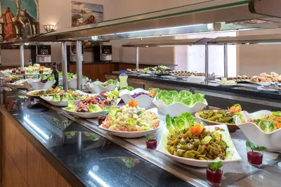 a buffet line with many plates of food at Eden Andalou Aquapark & Spa in Marrakech