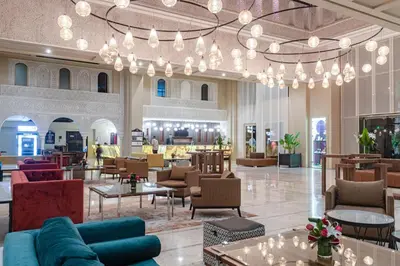 a lobby with couches and tables and chandeliers at Eden Andalou Aquapark & Spa in Marrakech