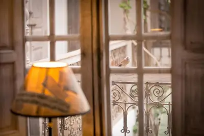 a bird sitting on a window sill next to a lamp at Riad Altair in Marrakech