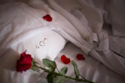 a group of red roses on a white blanket at Riad Altair in Marrakech