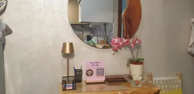 a desk with a mirror and a table with a clock at Bel appartement moderne au cœur de guelize in Marrakech