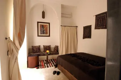 a bedroom with a bed and a couch in it at Riad Davia in Marrakech