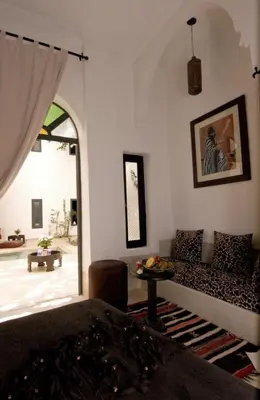 a living room with a couch and a table at Riad Davia in Marrakech