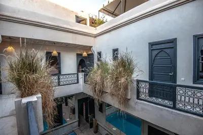 an apartment building with potted plants on the balconies at Riad Spa Sindibad in Marrakech
