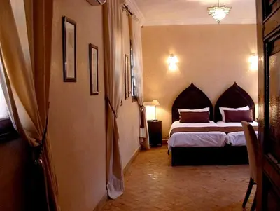 a bedroom with a large bed in a room at Riad Aderbaz in Marrakech